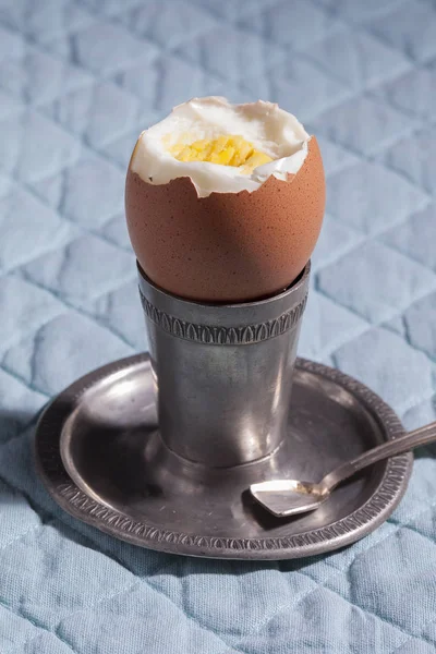 Hard boiled egg on a silver stand for breakfast