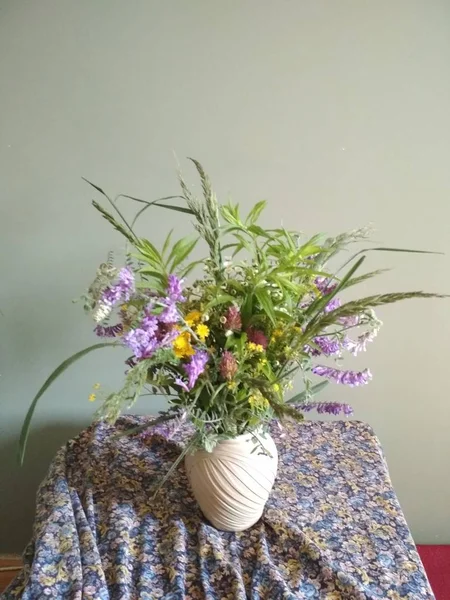 Yeşil Duvar Arka Plan Üzerinde Bir Vazo Içinde Kır Çiçekleri — Stok fotoğraf