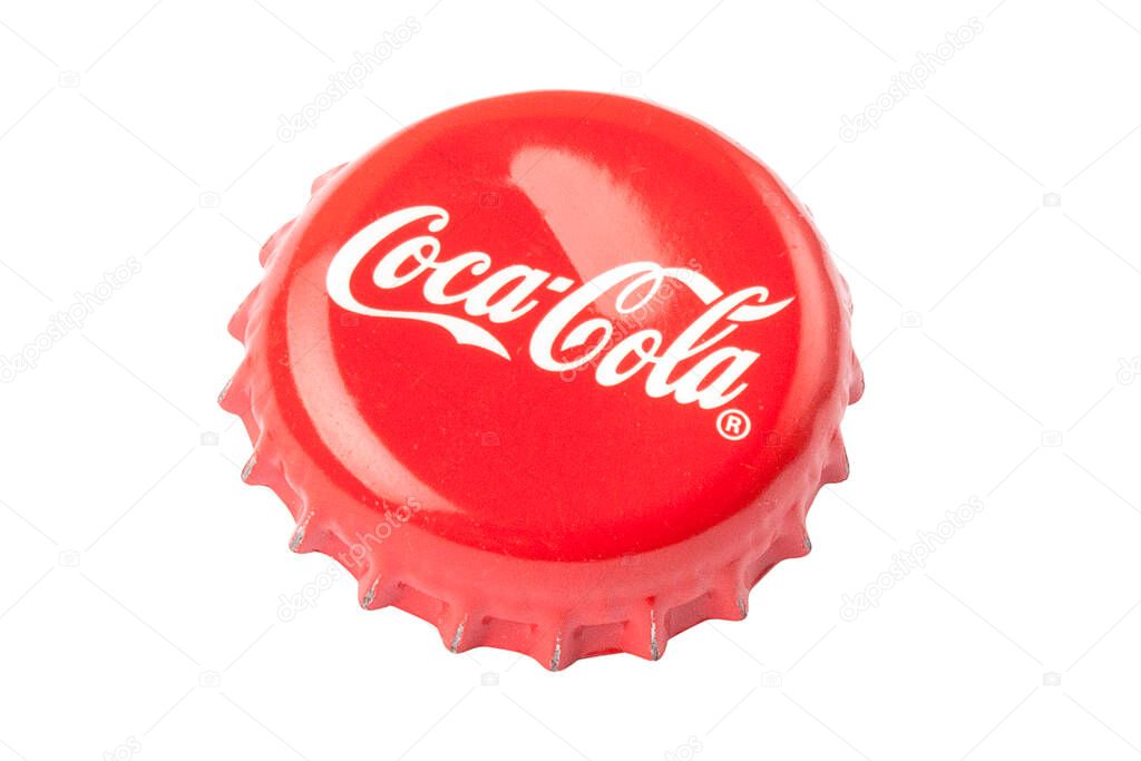 KIEV, UKRAINE - July 19, 2020: top view of a used red cap from a glass Coca-Cola bottle. Coca-Cola Company is an American corporation and manufacturer of drinks, founded in 1886.
