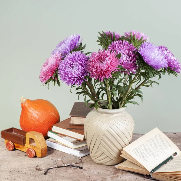 happy teachers day still life bouquet of asters and books on the background of the school board