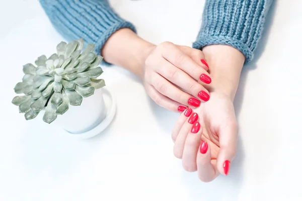 Perfect groomed womans hands with red nail varnish. — Stockfoto