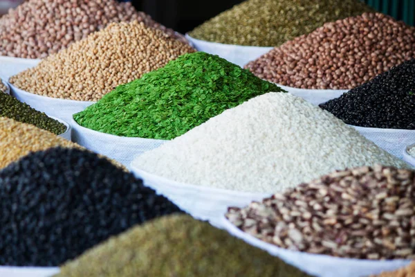 close up of a variety of groats in bags. Market.Vietnam. Colorful cereal grains. background