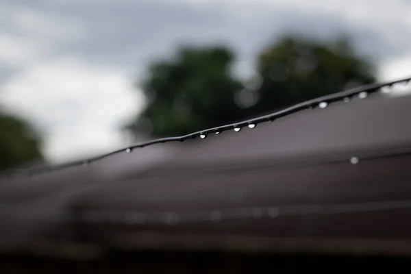Droplets of water hanging on clothesline after a stormy afternoon
