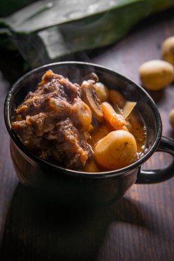 Potjiekos Güney Afrika kuyruklu güveç bebek altın patates havuç ve düğme mantar ile