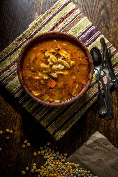 Rustic homecooked hearty tomato vegetable soup in a wooden bowl — Stock Image Rustic Homecooked Hearty Tomato Vegetable Soup Wooden Bowl Stock Photo