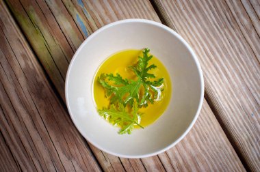 Ev yapımı sivrisinek kovucu yapmak için yağın içinde dinlenen bir sitronella yaprağı.