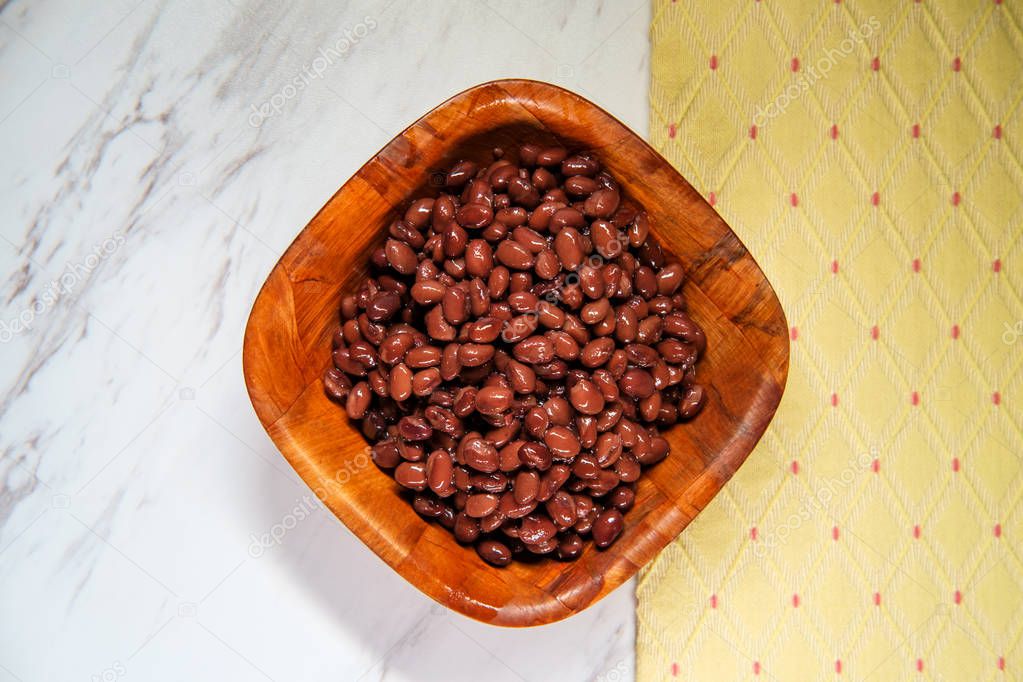 Chili ingredients wooden bowl black turtle beans on marble counter