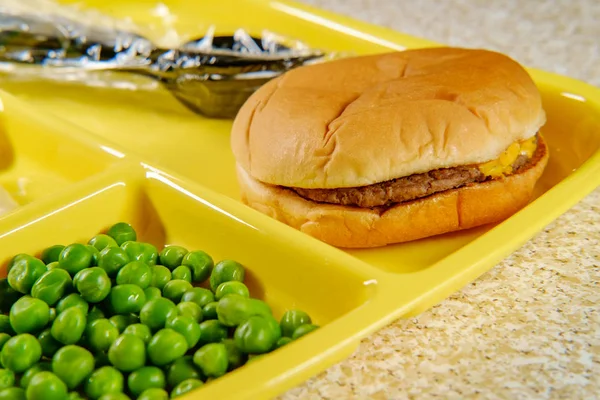 Grundschule Mittagessen Cheeseburger Mit Kartoffelpüree Gelatine Und Erbsen Auf Portionstablett — Stockfoto