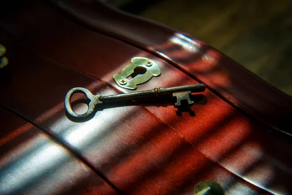Old antique skeleton key on distressed textured wooden background