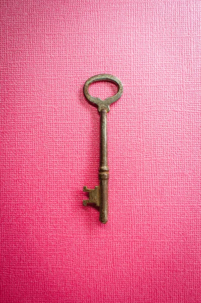 Old antique skeleton key on vivid colored background