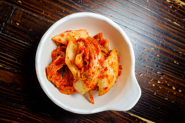 Bowl spicy korean kimchi with gochugaru chili pepper