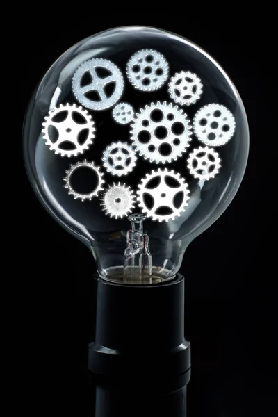 Light bulb with bright gears and cogs for brainstorming ideas concept