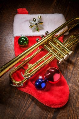 Seasonal Christmas and the holidays musical instrument trumpet with dramatic lighting clipart