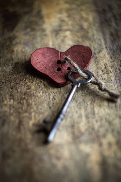 Key to my heart concept with antique skeleton key and rustic wooden heart
