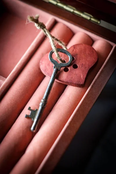 Key to my heart concept with antique skeleton key and rustic wooden heart