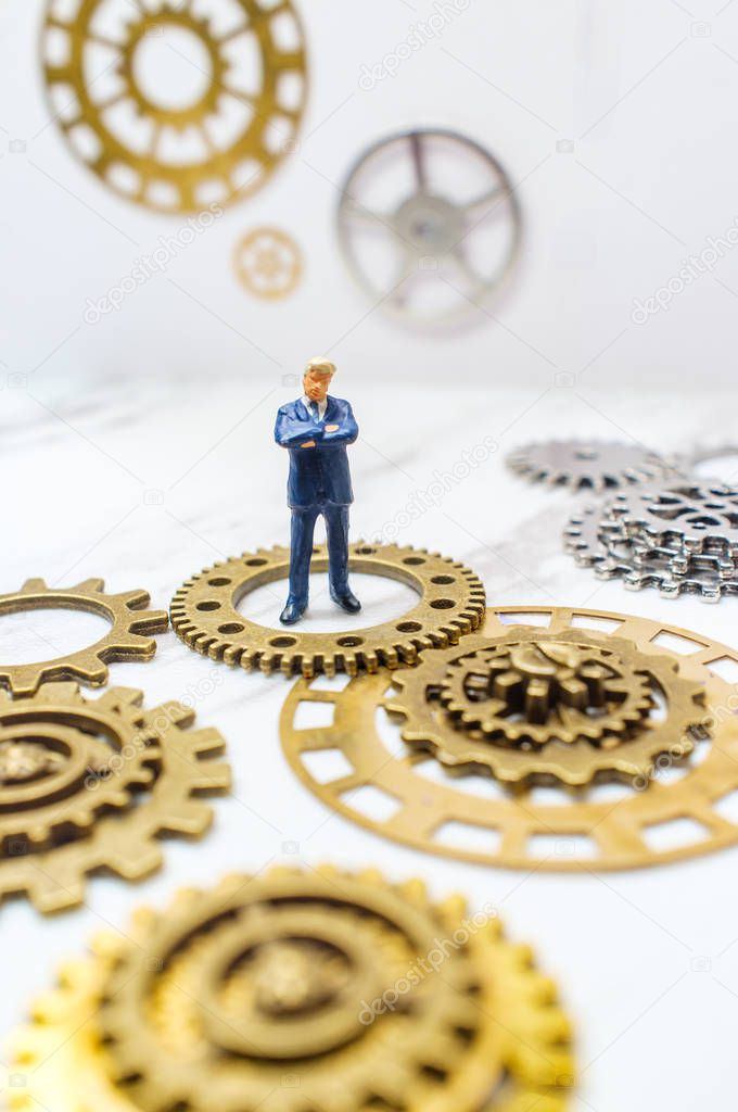 Businessmen surrounded by gears and cogs for innovation conceptual metaphor
