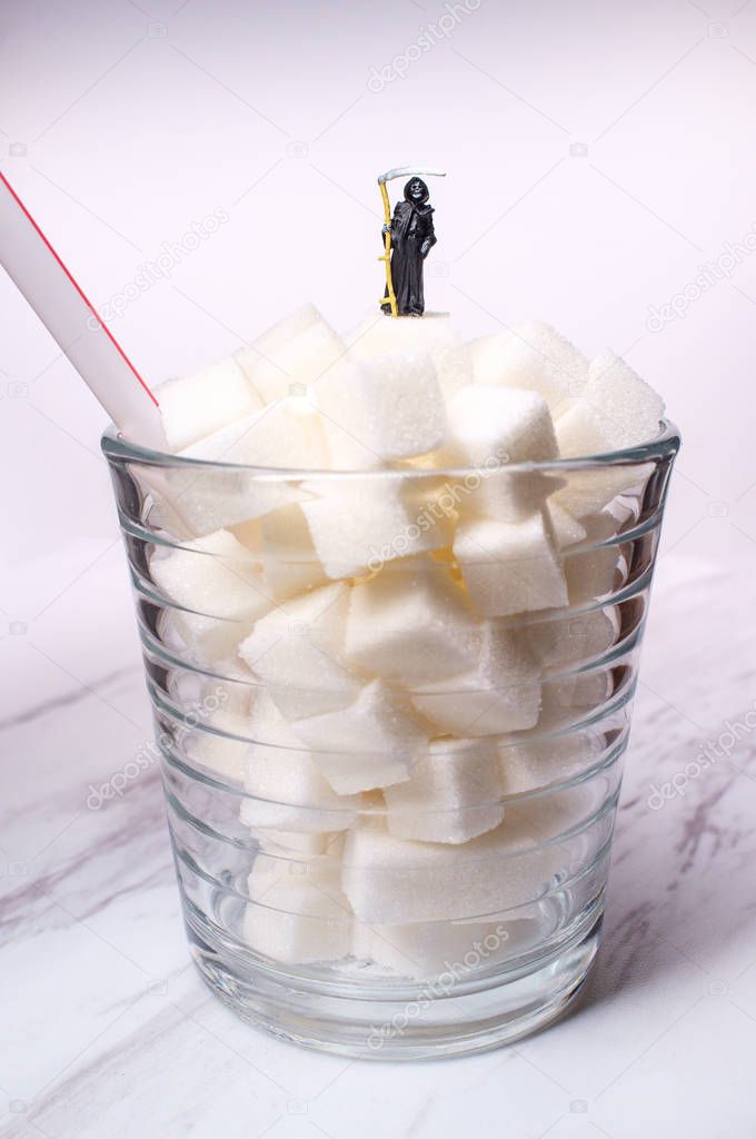 Conceptual sugar cubes in glass with grim reaper diabetes conceptual metaphor