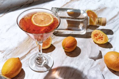 Mermer mutfak tezgahında pembe limonlu martini.