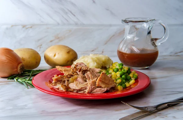 Southern American cuisine slow cooked barbecue pulled pork with creamy mashed potatoes and vegetables