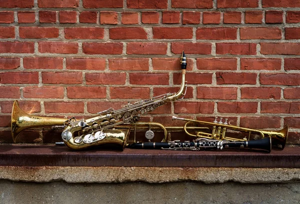 Musical Instruments Including Trombone Trumpet Clarinet Saxophone Brick Wall Jazz — Stock Photo, Image