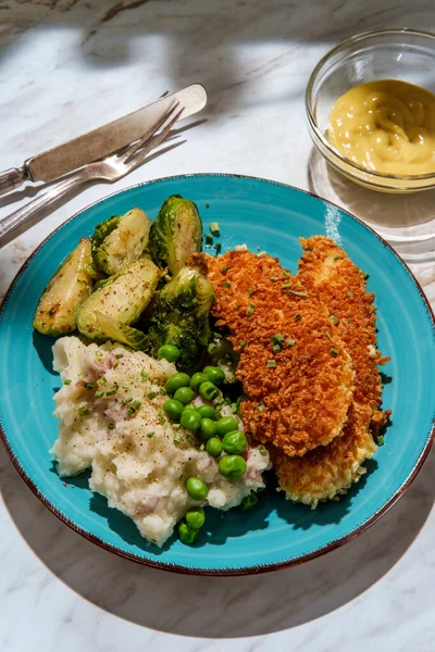 Country style chicken fingers mashed potatoes brussels sprouts peas and honey mustard for dipping