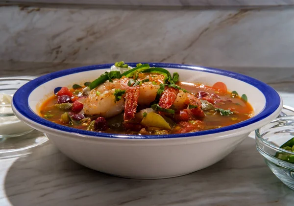 Hot and spicy bowl of Chili con carne with shrimp jalapeno and sour cream