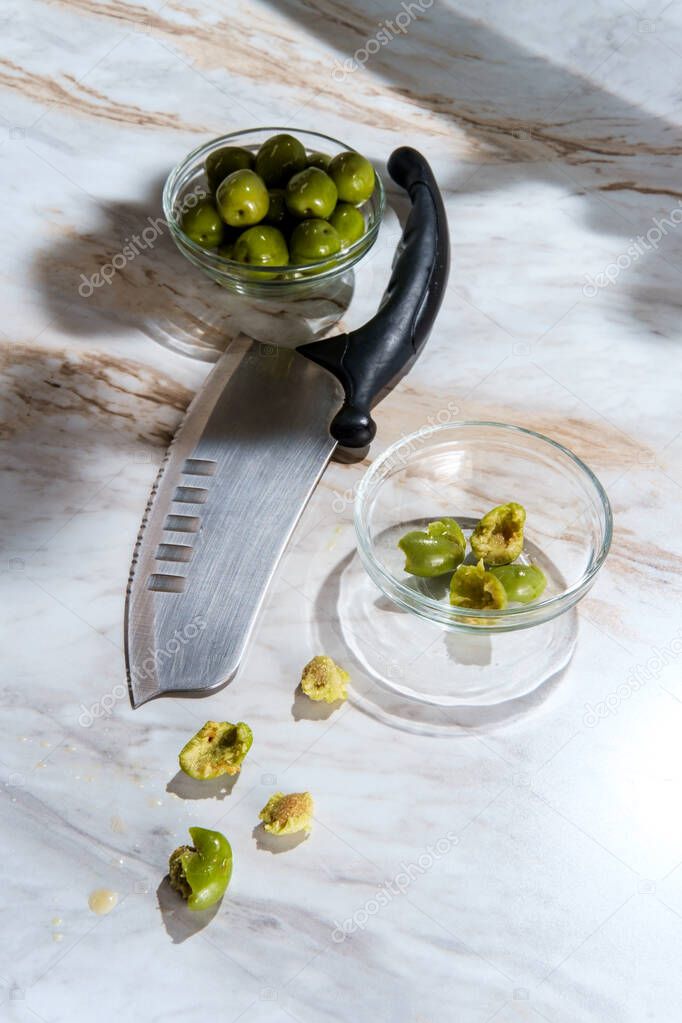 Nocellara del Belice or castelvetrano olives pitted and torn with a knife