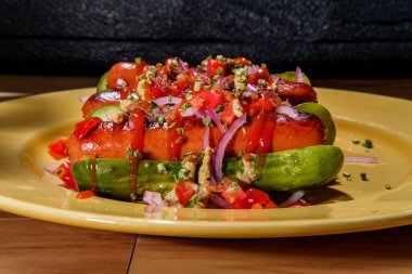 Bun glütensiz sosisli için turşu dilimlenmiş kırmızı soğanlı sosisli pastırma parçaları ve süslü malzemeler için soğan soğanı.