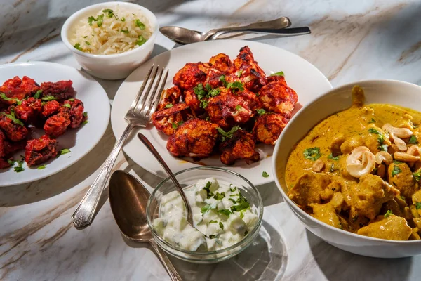 Indian dinner korma with mushroom 65 tandoori cauliflower rice and raita