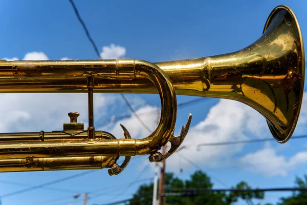Trumpet against blue sky during marching band celebration