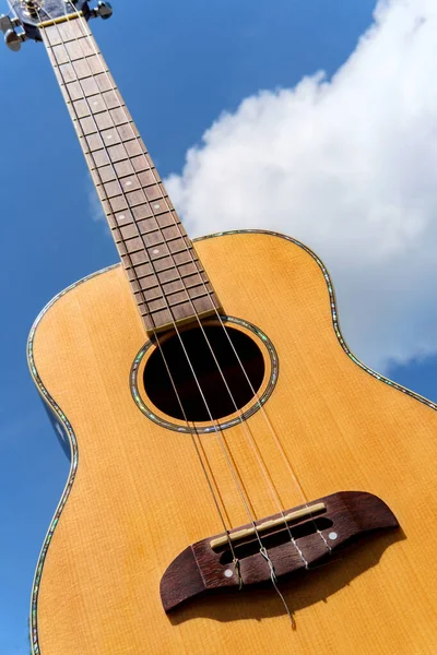 Acoustic Baritone Ukulele Guitar Held Bright Blue Sky Fluffy Clouds — Stock Photo, Image