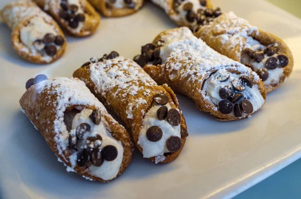 Italian dessert chocolate chip cannoli with powdered sugar