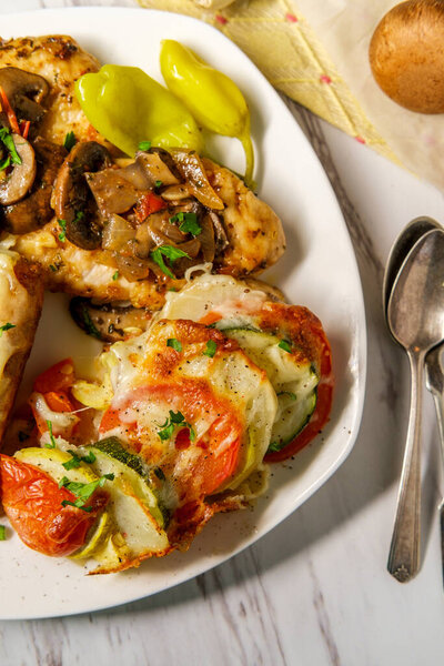 Italian chicken marsala with French vegetable tian and stuffed sausage