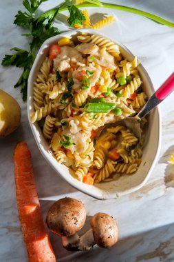 Pencereden içeri güneş ışığı süzülen tavuklu makarna güveci