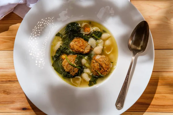 Italian wedding soup with meatballs conchiglie pasta and spinach