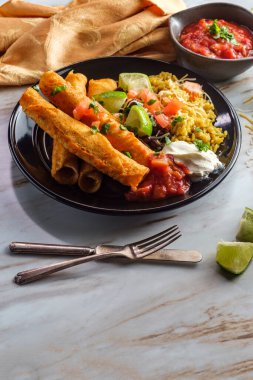 Meksika usulü taco tavuk ve peynirli taco pilav ve siyah fasulye.