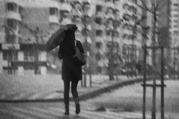 Woman with umbrella in the city during heavy rain