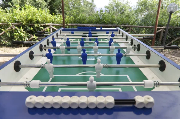 Soccer table game with white and blue figures