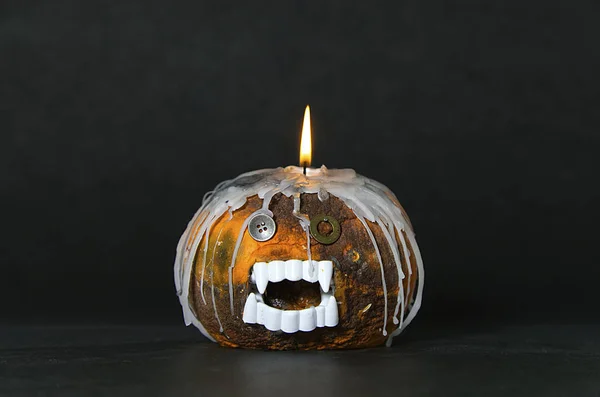 scary and ugly pumpkin with a candle on the head