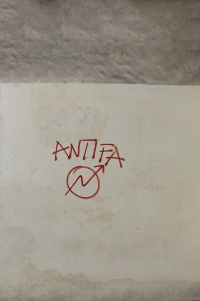 Antifa sign and graffiti tag