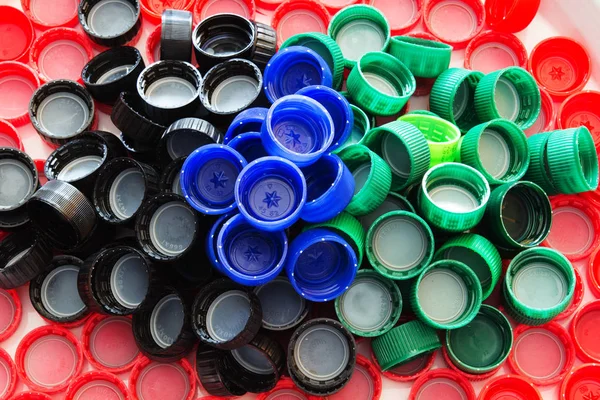 Many colored plastic caps of bottles. Eco concept.