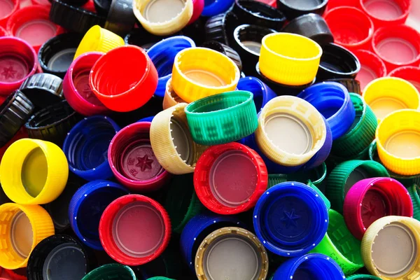 Many colored plastic caps of bottles. Eco concept.