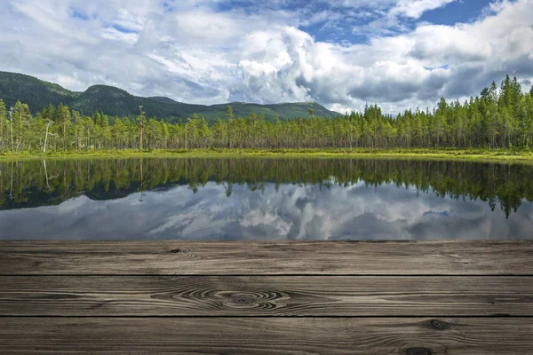 Wooden table from boards on forest mountain lake background