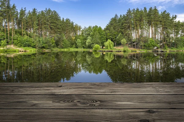 Wooden table from boards on landscape of forest lake background