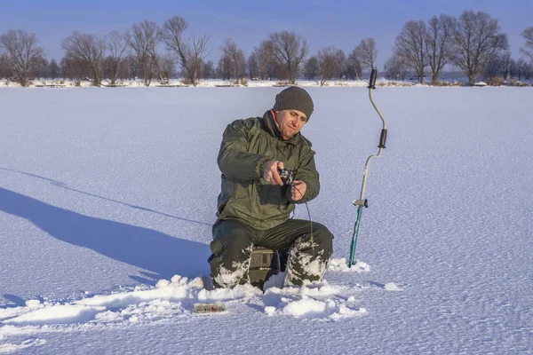 Winter Fishing Concept Fisherman Action Catching Fish Snowy Ice — Stock Photo, Image