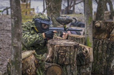 Paintball oyuncusu nişan alır, gizler ve çekim. Adam giyen Prot