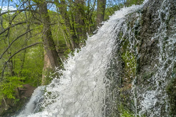 Mountain river waterfall landscape. View from bottom of Dzhurynskyi waterfall stream. Nyrkiv, Ukraine