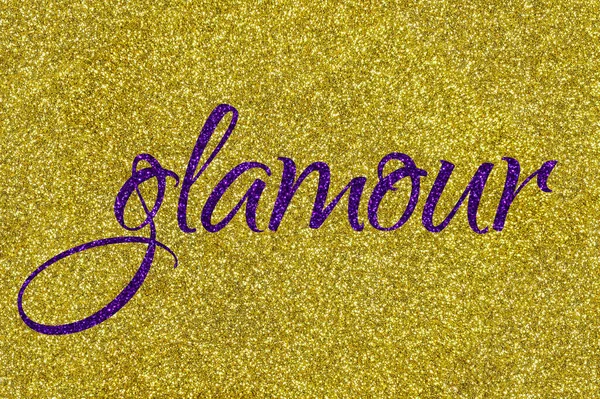 Glamour lettering word ultra violet on gold glitter texture. Shiny sparkle background