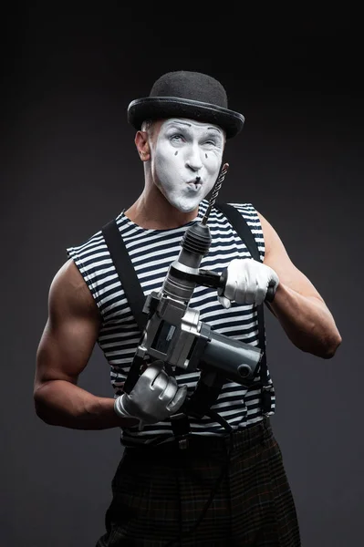 Concept When neighbors are noisy. Clown mime holding a puncher.