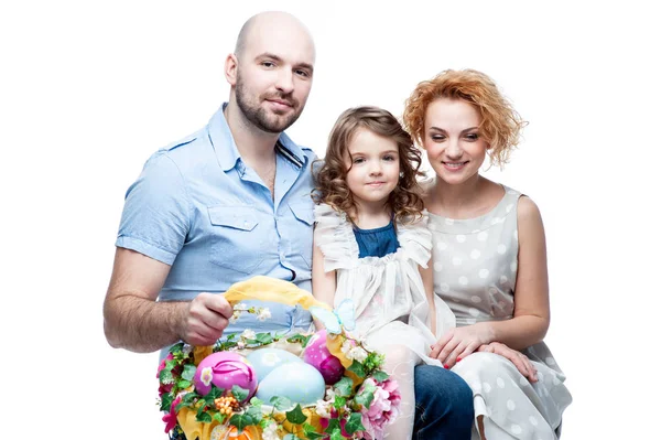 Parents and daughter holding basket with Easter eggs — Stock Photo, Image